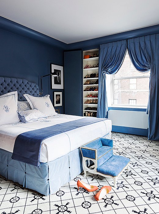 Enveloping your bedroom, and yourself, in deep blue encourages you to relax and ease into sleep. At the same time, a white ceiling, white sheets, and a rug that’s largely white will help you start your day on a lighter note. Room by Kate Rheinstein Brodsky; photo by Lesley Unruh.
